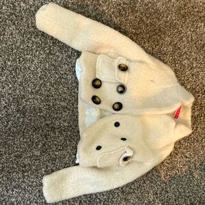 Manoush wool jacket with two layers, pockets, and bow at the back.